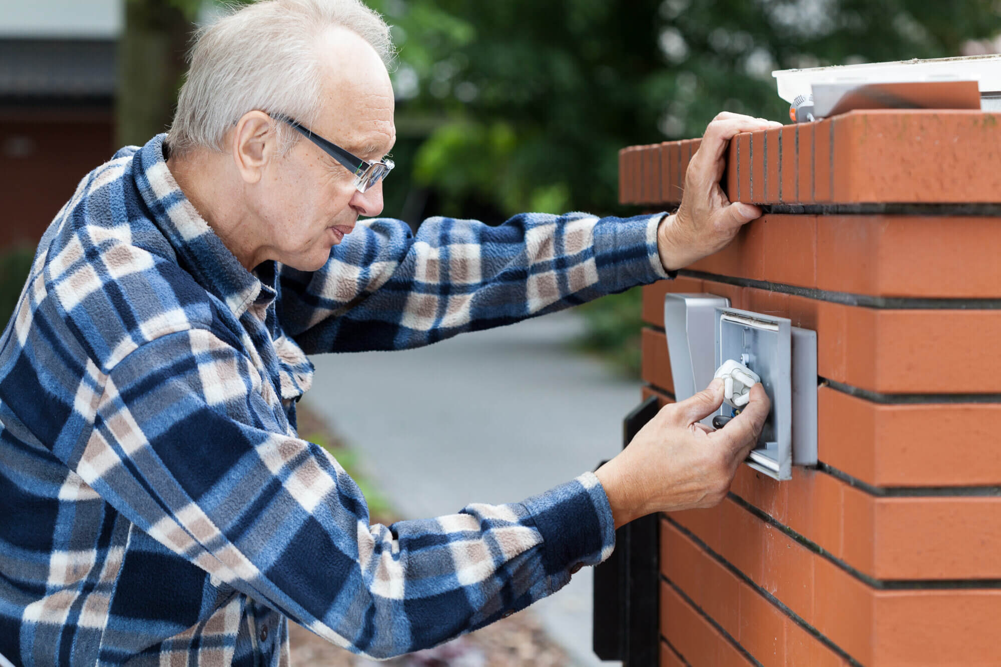 Old man repairing intercom 