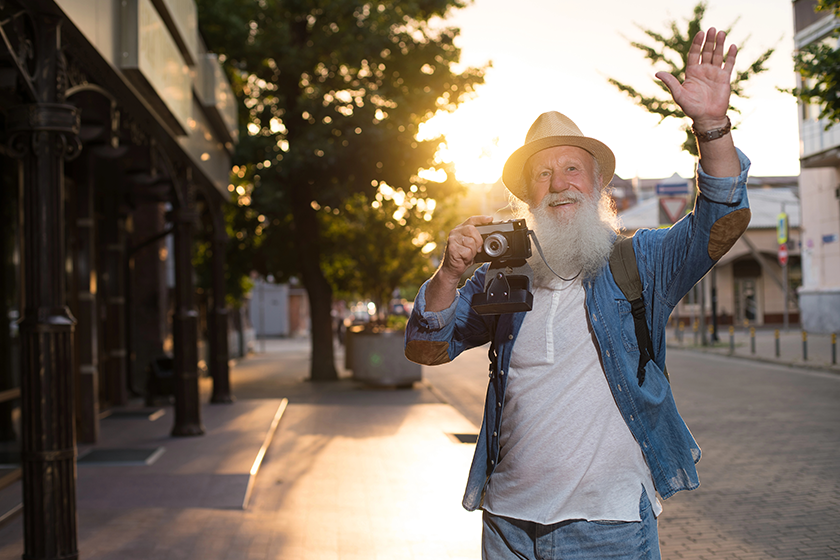 Happy smiling mature man keeping device 